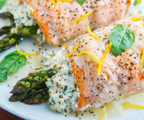 Salmon rolls stuffed with a summery lemon and basil ricotta and asparagus that is baked and served with a fresh and tasty lemon sauce